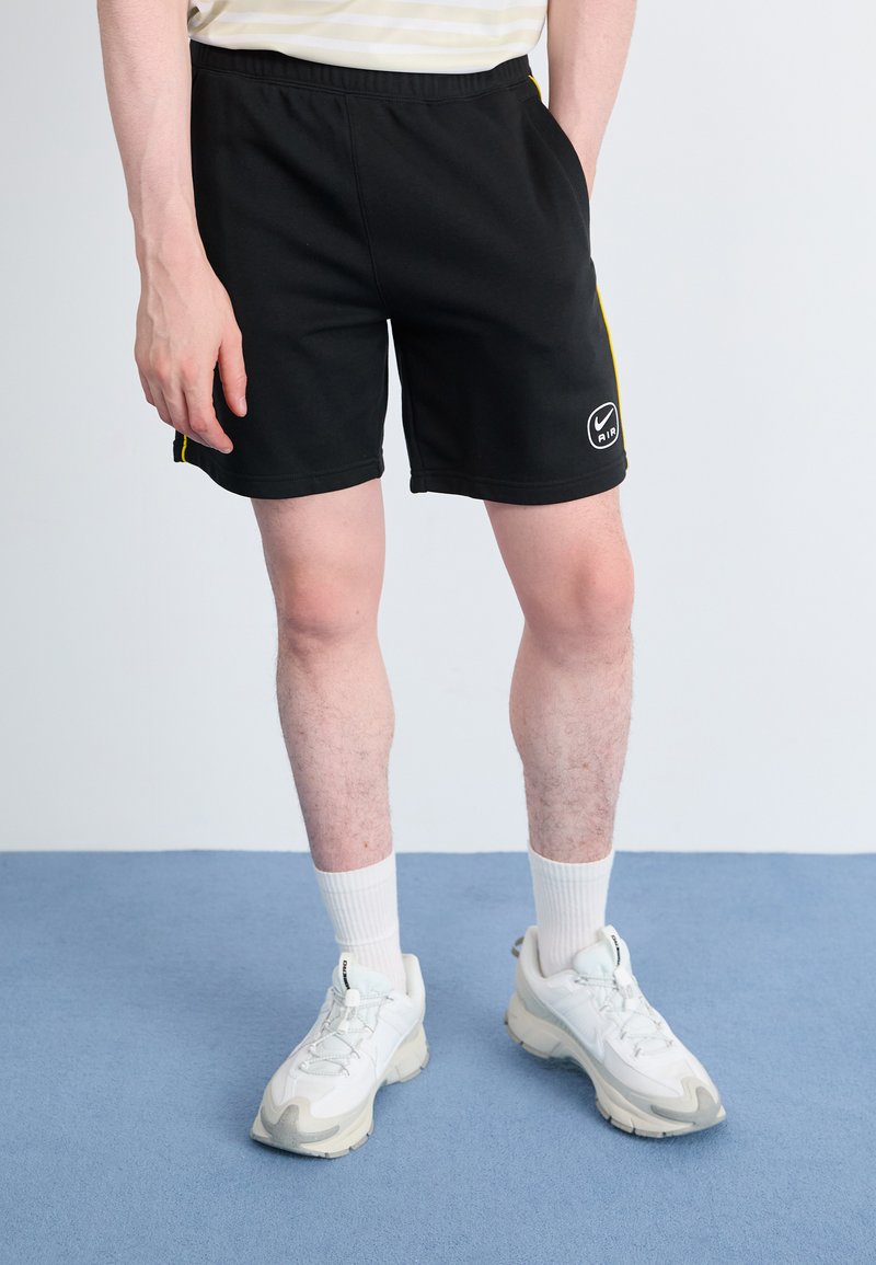 Nike Sportswear - Tracksuit bottoms - black/lightening, Enlarge