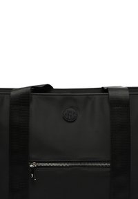 Black fabric bag with sturdy shoulder straps, featuring a front zip pocket and embossed logo for distinctive branding. Smooth texture.