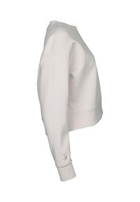 Ljusbeige sweatshirt, rund hals, mjukt material, långa ärmar, manschettdetalj med detaljer i metall, kortad design, platta sömmar.