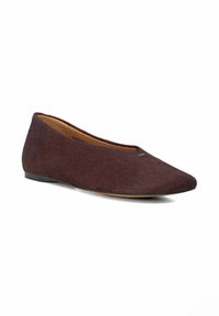 Burgundy flat shoe made from soft fur-like material, featuring a rounded toe and a low black sole for easy wear.