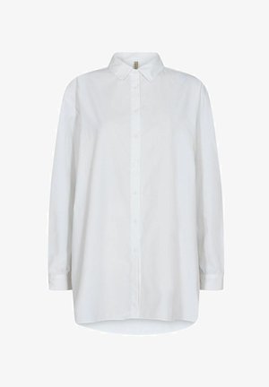 Chemise blanche à boutons, avec un col, des manches longues et un ourlet arrondi. Fabriquée en tissu lisse avec un design uni sans motifs.