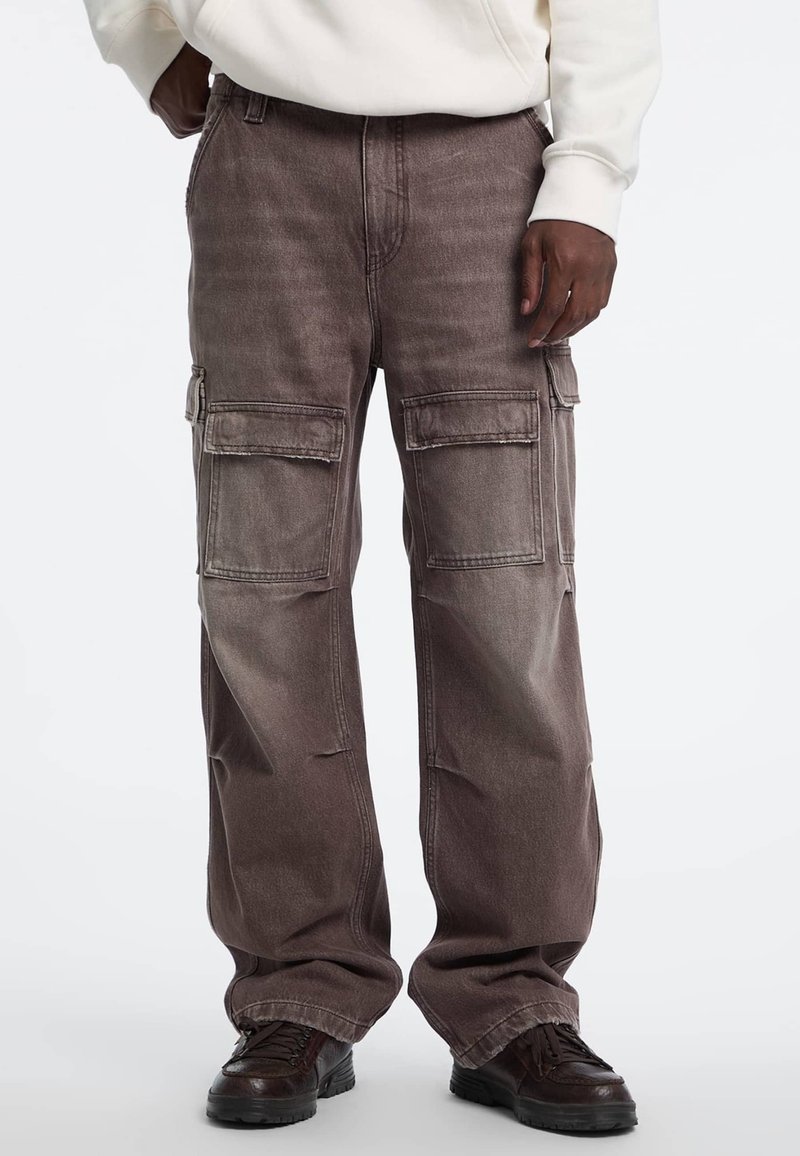 Grijze cargobroek met een losse pasvorm, voorzien van meerdere zijzakken en een vervaagde textuur. Gemaakt van duurzaam stof met zichtbare stiksels.