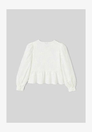 Blouse blanche à manches longues avec broderie florale, encolure ronde et bas à volant. Manches froncées et poignets à boutons. Tissu texturé.