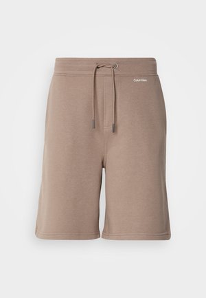 Brown cotton shorts with elastic waistband, drawstring closure, and logo detail on the front. Soft texture and knee-length design.