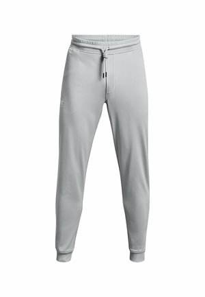 Lichtgrijze sweatpants van zachte stof, met een elastische tailleband, koord en taps toelopende boorden. Subtiele branding aan de zijkant.