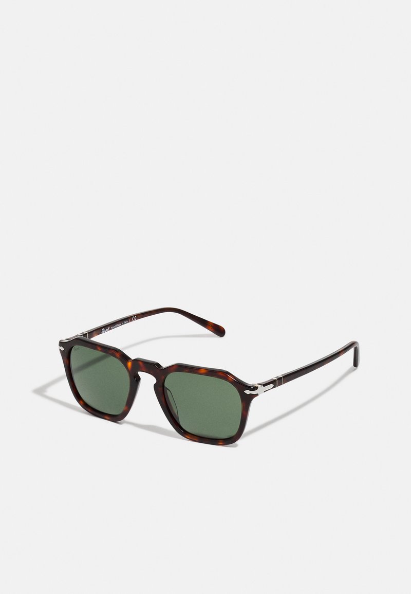Brown tortoiseshell sunglasses with green lenses, featuring a bold, angular frame and stainless steel accents on the temples.