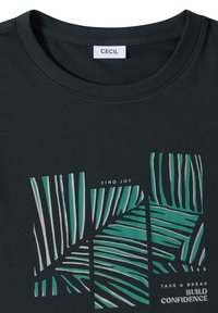 T-shirt vert foncé à col rond, illustration de feuille de palmier et texte motivationnel : « TROUVEZ LA JOIE », « PRENEZ UNE PAUSE » et « DÉVELOPPEZ LA CONFIANCE ».