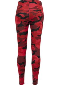 Røde camo leggings med en blanding av mørkerøde, lyserøde og svarte mønstre. Laget av glatt, elastisk stoff med en tettsittende design.