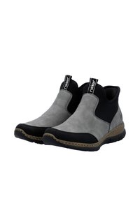 Bottines grises et noires avec un contraste entre un matériau en daim et un matériau lisse, des panneaux latéraux élastiques et un bout texturé noir. Semelle en caoutchouc avec un bord de couleur naturelle.