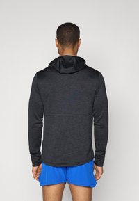 New Balance GRID BALACLAVA HOODIE - Pikkade varrukatega topp - black