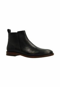 Bottine noire en cuir avec une finition lisse, des panneaux élastiques sur les côtés, un bout rond et une semelle marron contrastante. Elle dispose d'une languette pour un enfilage facile.