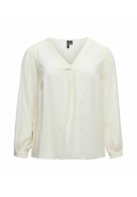 Blouse à manches longues couleur crème clair avec un col en V, coupe décontractée, tissu texturé, et poignets froncés, présentant un détail drapé central à l'avant.