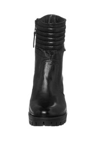 Botines de cuero negro con parte superior texturizada y fruncida, cremallera lateral y una suela robusta para mayor tracción. Acabado suave con detalles de costura.
