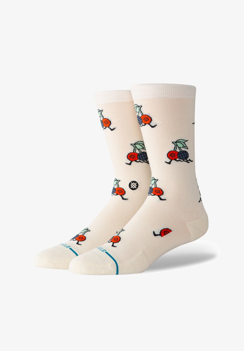 Térd fölé érő, világos krémszínű zoknik, színes gyümölcs és rovar mintákkal, piros és kék részletekkel, valamint türkizsávval a lábujjaknál.