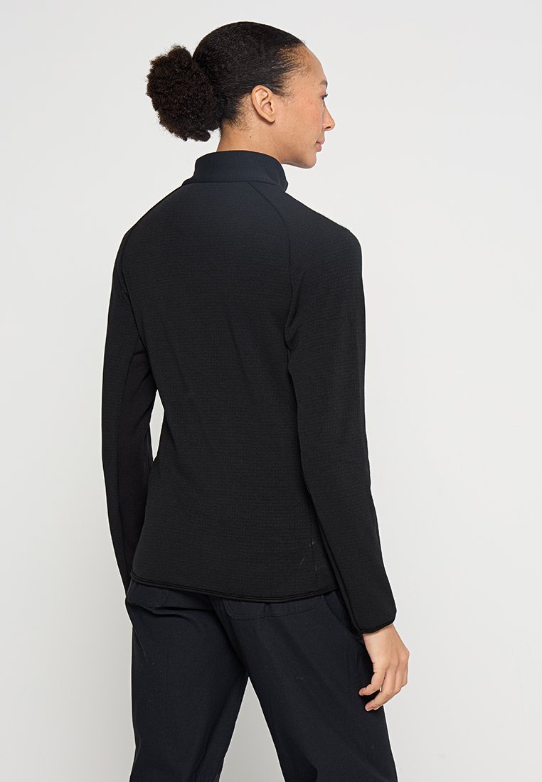 Schwarze Reißverschlussjacke mit hohem Kragen, strukturiertem Stoff, langen Ärmeln und schlanker Passform. Verfügt über flache Nähte und einen leichten Stretch.