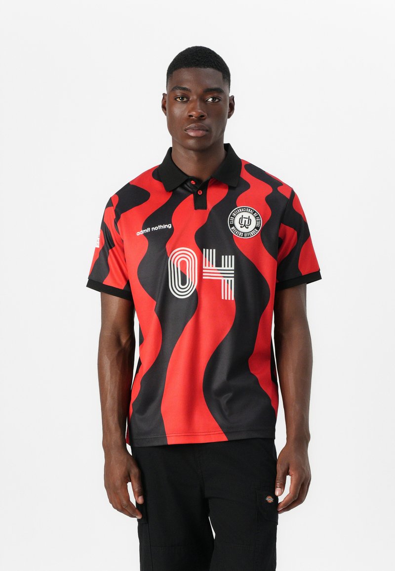 Red and black polo shirt with a wavy pattern, short sleeves, and a black collar. Features the number "04" and a circular logo on the chest.
