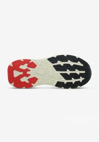 Suola di sneaker in gomma nera e rossa con motivi testurizzati, intersuola bianca e un design del battistrada distintivo per una migliore trazione.