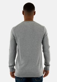 Maglione grigio in maglia con polsini e orlo a coste, dotato di scollatura a giro e design delle spalle senza cuciture, visto dalla parte posteriore.