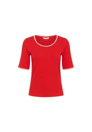 Rdeča rebrasta majica s kratkimi rokavi, ki ima okroglo ovratnico in belo valovito obrobo na ovratniku in manšeteh. Gladka tekstura.