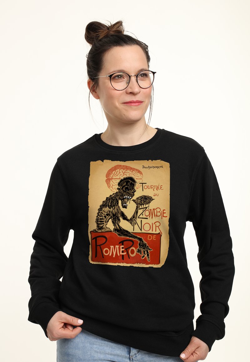 Felpa nera con stampa grafica di una figura scheletrica che tiene in mano un cervello, con testo in rosso e beige. Materiale in misto cotone.