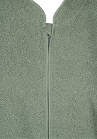 Fleecejacka i dämpad grön färg med dragkedja. Texturen är mjuk och plyschig, med rundad halsringning och minimalistisk design.