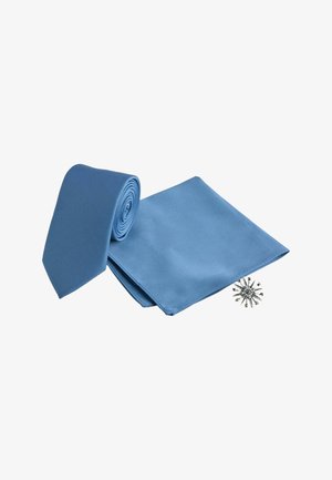 Rolled light blue necktie, matching pocket square, and silver starburst lapel pin arranged on white background.