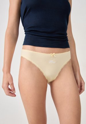 Beige cotton panties with lace trim, a bow on the front, and embroidered detail. The fabric appears soft, with a smooth texture.