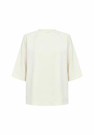 T-shirt oversize color crema con maniche corte, collo rotondo e texture liscia. Presenta maniche raglan e un design a vestibilità rilassata.