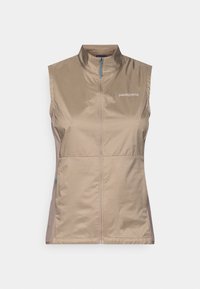 Lekki bezrękawnik w kolorze khaki z wysokim kołnierzem i zamkiem błyskawicznym z przodu. Posiada niebieski uchwyt zamka i logo Patagonia na klatce piersiowej.