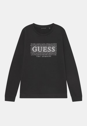 Czarny długi rękaw bluza z okrągłym dekoltem, z błyszczącym srebrnym logo "GUESS" z napisem "LOS ANGELES" pod spodem oraz prążkowanymi mankietami.
