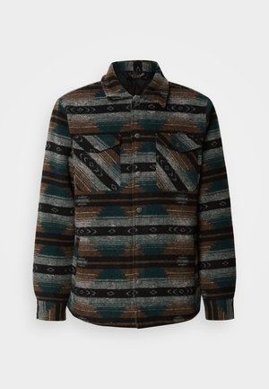 Multi-colored patterned flannel shirt-jacket featuring shades of green, brown, and gray, with two chest pockets and button closures.