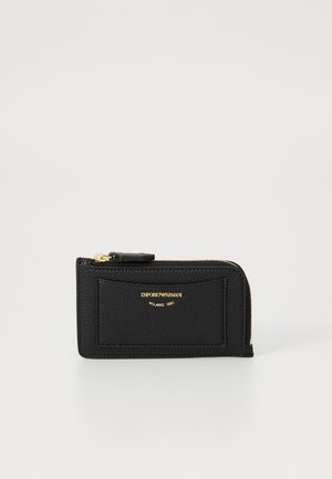 Black leather wallet with a textured finish, zip closure, gold-tone logo, and a front slip pocket. Compact, rectangular design.