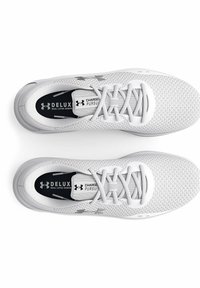 White athletic shoes with mesh upper, black insoles marked "CHARGED PURSUIT," and silver logo accents. Lightweight design, round toe.