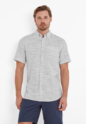 Short-sleeve button-up shirt in a light gray fabric with a subtle horizontal stripe pattern and a single chest pocket. Paired with navy shorts.