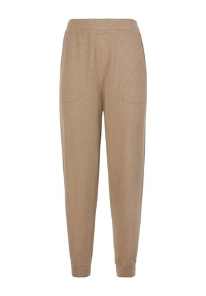 Beige Strickhosen mit elastischem Bund, seitlichen Taschen und gerippten Bündchen an den Knöcheln.