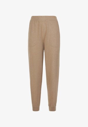 Beige Strickhosen mit elastischem Bund, seitlichen Taschen und gerippten Bündchen an den Knöcheln.