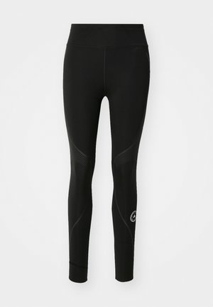 Leggings de sport noirs avec une texture lisse, dotés d'une taille haute et de panneaux texturés contrastants sur les côtés.
