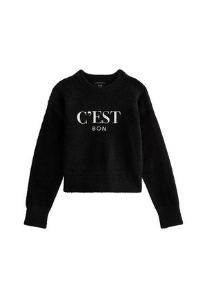 Pull noir en peluche, court, avec un col rond et des manches longues. Présente le texte blanc "C'EST BON" sur le devant. Texture douce.