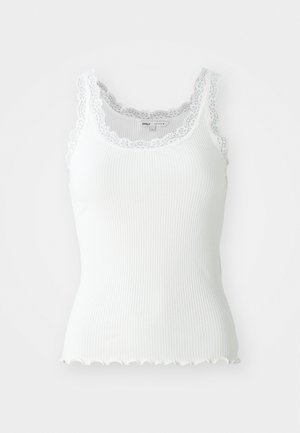 White ribbed tank top with lace trim along neckline and armholes; scalloped hem detail; fitted design and lightweight fabric.