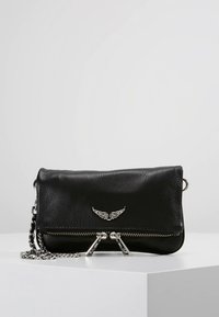 Black leather crossbody bag with silver winged hardware, double zip closure, and a chain strap. Textured surface with a sleek, minimalist design.