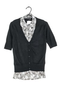 Black cardigan with short sleeves, featuring a V-neck and button closure, layered over a gray floral-patterned shirt with a round collar.