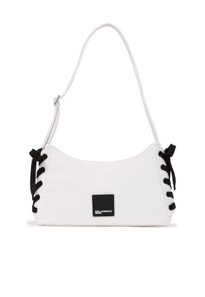 Valge õlakott, mille külgedel on mustad pitsiline detail ja esiküljel väike must ruudukujuline logo, millel on kiri "Karl Lagerfeld Jeans".