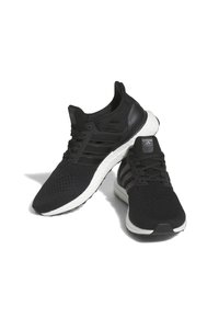 Black Adidas running shoes with white cushioned soles and three black stripes on the sides, positioned crossing each other on a white background.