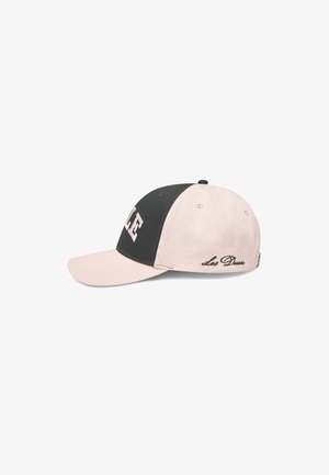 Baseball cap with a black front panel and pale pink visor and back. Features text "LE" on the front and "Les Deux" embroidered on the side.