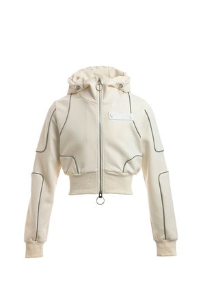 Sudadera corta color crema con capucha, cremallera, puños y dobladillo acanalados, y detalles de ribete oscuro en las mangas y el cuerpo.