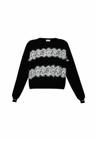 Maglione nero con ampie strisce di pizzo bianco, maniche lunghe con polsini e scollatura rotonda. Il pizzo presenta motivi floreali intricati.