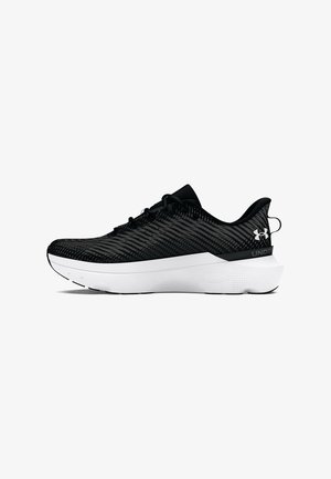 Black athletic shoe featuring a textured mesh upper, rounded toe, white midsole, and contrasting black heel with logo detail.