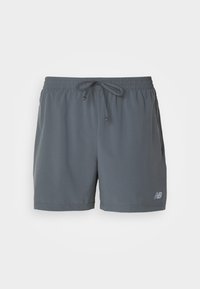 Calças de desporto cinzentas com faixa elástica na cintura e cordão, apresentando bolsos laterais e um pequeno logótipo da marca na parte inferior da perna esquerda.