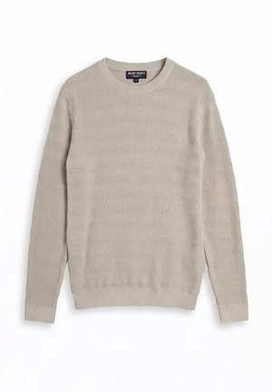 Pull en tricot beige clair à col rond avec un motif subtil en forme de vagues, manches longues, poignets et ourlet côtelés, taille moyenne.
