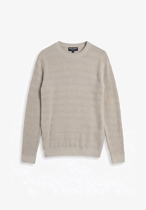 Pull en tricot beige clair à col rond avec un motif subtil en forme de vagues, manches longues, poignets et ourlet côtelés, taille moyenne.